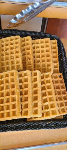 a stack of waffles sitting on top of a basket at ibis budget Meung sur Loire in Meung-sur-Loire