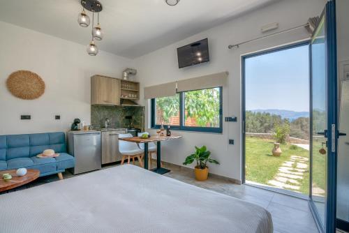 a kitchen and living room with a large window at Cavos Luxury Apartments in Kissamos