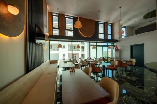 a restaurant with tables and chairs in a room at Air Barbaros Hotel Trabzon in Trabzon