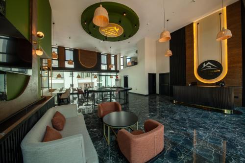 a lobby with chairs and tables in a building at Air Barbaros Hotel Trabzon in Trabzon