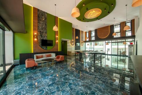 a lobby with green walls and a blue marble floor at Air Barbaros Hotel Trabzon in Trabzon