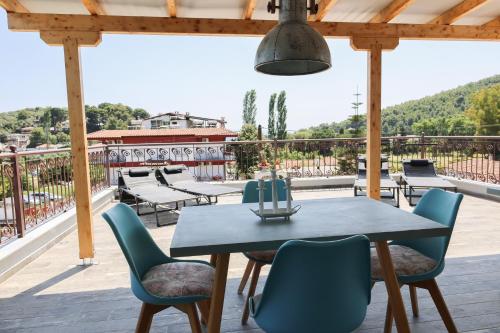 a patio with a table and chairs on a deck at KT Villa in Troulos