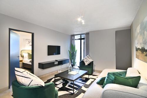 a living room with a couch and a table at Circa Aparthotel by Totalstay in Pretoria