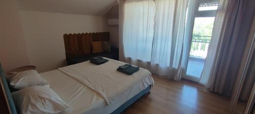 a bedroom with a bed with two towels on it at Apartments Provence in Sozopol