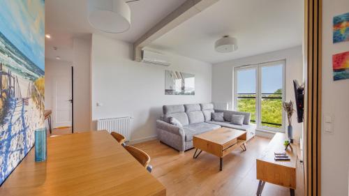 a living room with a table and a couch at Nexo, Sun & Snow in Puck