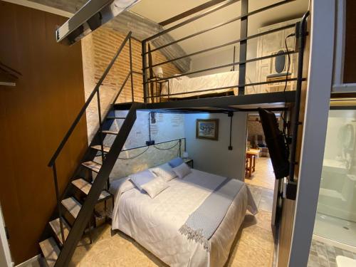 a bedroom with a bunk bed and a spiral staircase at CASA RUINA in Nava del Rey