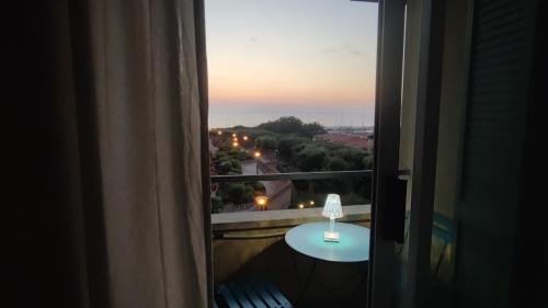 a room with a window with a table and a view at Bellavista Punta Ala in Punta Ala