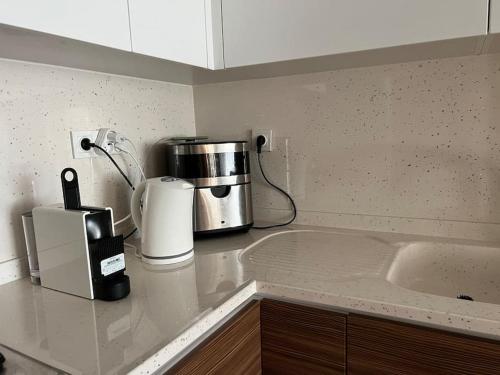 a kitchen counter with a coffee maker and a microwave at Seaside Serenity.Kusadasi,Turkey in Kusadası