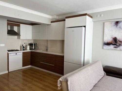 a kitchen with a white refrigerator and a counter at Seaside Serenity.Kusadasi,Turkey in Kusadası