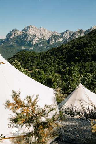 a white tent with mountains in the background at Ursa Camp in Gornje Lipovo