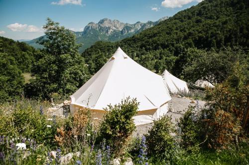 a white tent with mountains in the background at Ursa Camp in Gornje Lipovo
