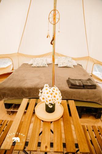 a room with a bed and a table with a cake at Ursa Camp in Gornje Lipovo