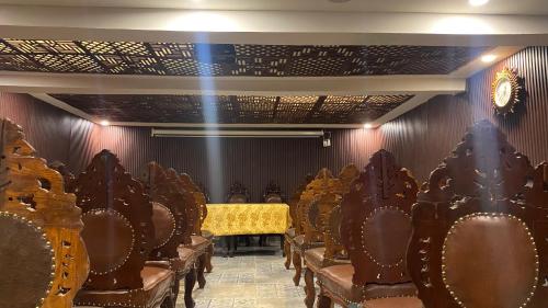 a row of chairs in a room with a table at HYDERS PARK- THE LUXURY HOTEL in Kodaikānāl