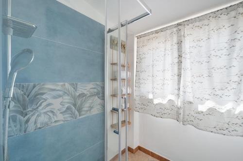 a bathroom with a shower with a glass door at Le tenute del mandarino in Elmas