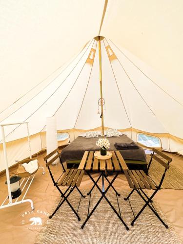 a tent with a table and chairs in a room at Ursa Camp in Gornje Lipovo