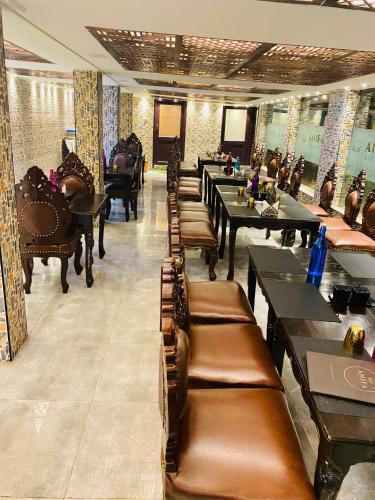a row of tables and chairs in a restaurant at HYDERS PARK- THE LUXURY HOTEL in Kodaikānāl