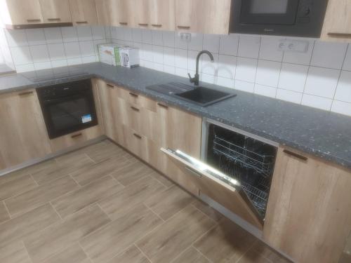 an empty kitchen with a sink and a stove at Ubytování Stračenská in Štětí