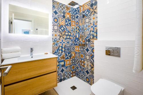 uma casa de banho com um chuveiro, um WC e um lavatório. em CASA 4YOU em Carvoeiro