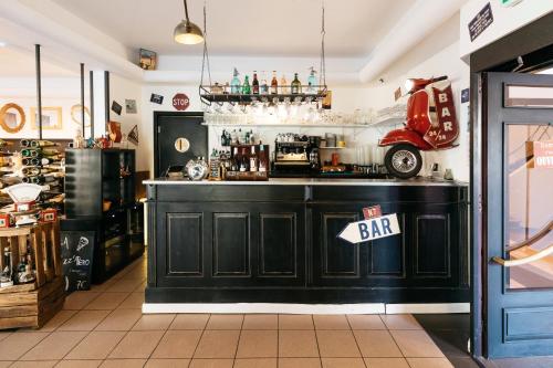 a bar in a restaurant with a bar sign on it at Hôtel Restaurant La Voile - Le Dock'er in Locmariaquer