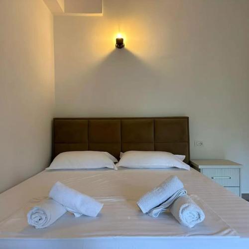 a bed with two towels on top of it at Vila Zisi Himare in Himare