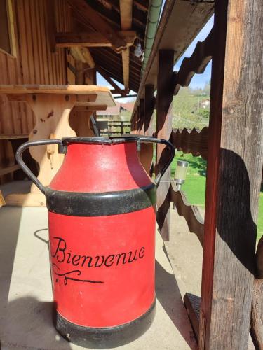 a red and black bucket sitting on a table at ACCOTINAE in Mont-Saxonnex