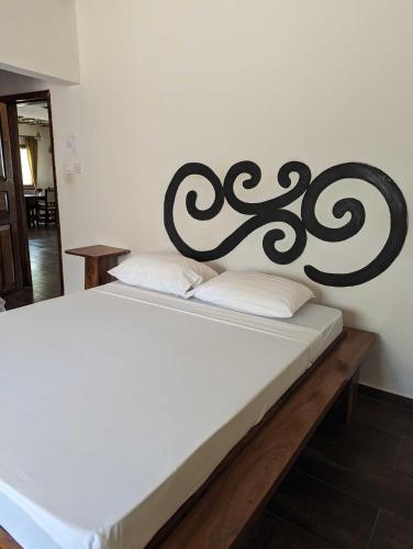 a bed with a black and white headboard in a room at Surfescape Zanzibar in Kiwengwa