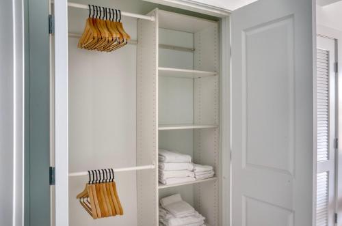 a bathroom closet with white shelves and towels at Pioneer Square studio w lounge gym nr bay SEA-587 in Seattle