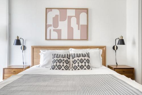 a bedroom with a large bed with two lamps at Navy Yard 1BR w Gym WD steps from Nats Park WDC-325 in Washington, D.C.