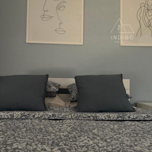 a bed with two pillows on top of it at Apartman Indigo in Vrnjačka Banja