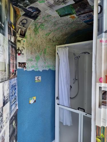 a map on the wall of a bathroom with a shower at Glamping in style, Prospector Tent in Crawley