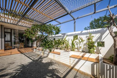 an outdoor patio with a bench and plants at PAMY Homestay Phú Yên in Phu Yen