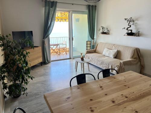 un salon avec un canapé et une table dans l'établissement Appartement avec magnifique vue mer, à Ajaccio