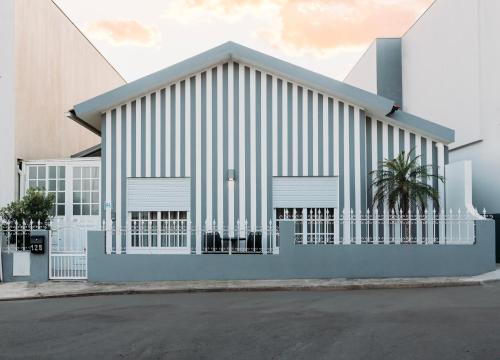 a large white building with a white fence at Argus Dream Home in Costa Nova