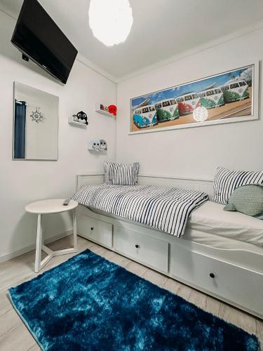 a bedroom with a bed and a blue rug at Argus Dream Home in Costa Nova