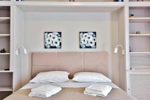 a bedroom with a bed with two white pillows at Melia Residence Acropolis - NEW in Athens