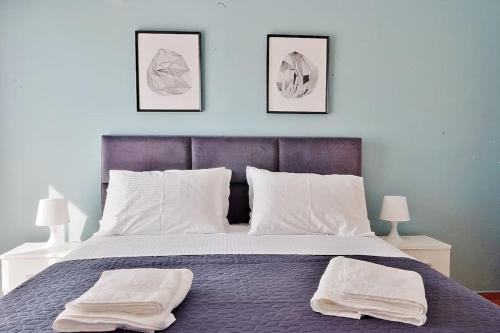 a bedroom with a bed with two towels on it at Melia Residence Acropolis - NEW in Athens