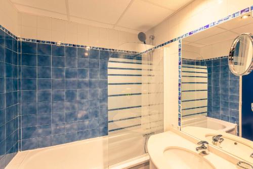 a bathroom with a tub and a toilet and a sink at Best Western Marseille Aeroport in Vitrolles