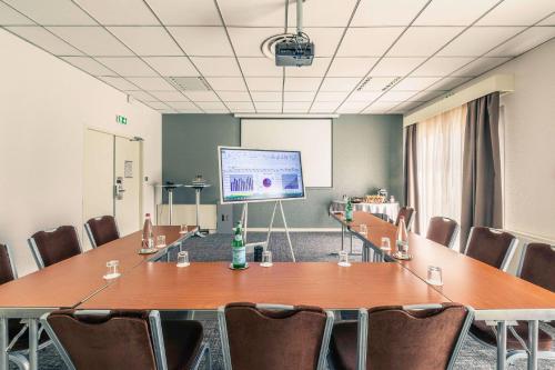 a conference room with a large table and chairs at Best Western Marseille Aeroport in Vitrolles