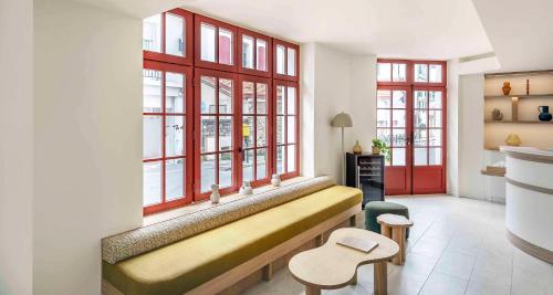 een woonkamer met een bank voor de ramen bij Best Western Kemaris in Biarritz