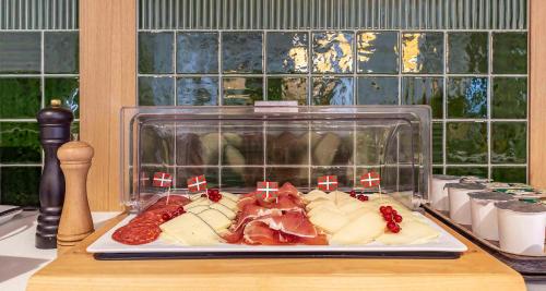 a plate of food in a glass container on a table at Hôtel Kemaris in Biarritz