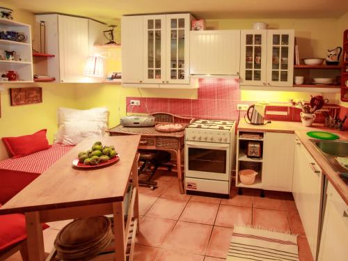 a kitchen with a table with a plate of fruit on it at Chalet Karasova II by Interhome in Dehtáře