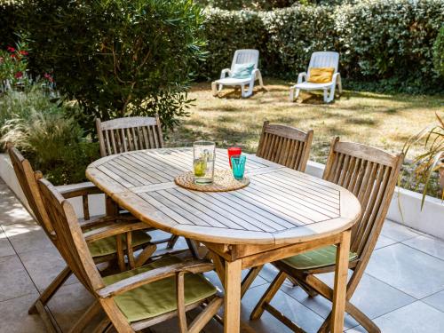 a wooden table with chairs and drinks on it at Holiday Home Les Narcisses by Interhome in Ronce-les-Bains