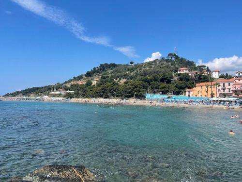 a view of a beach with people in the water at Holiday Home Le Antiche Volte - SLR215 by Interhome in Cipressa