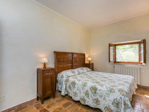 a bedroom with a bed and a window at Apartment Santa Marta by Interhome in Cinigiano