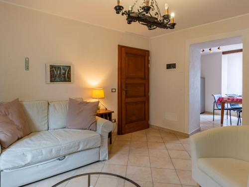 a living room with a white couch and a table at Apartment della Nonna by Interhome in Musignano
