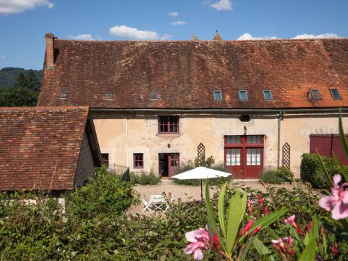 an old building with an umbrella in front of it at Holiday Home La Maison du Chateau by Interhome in La Tagnière