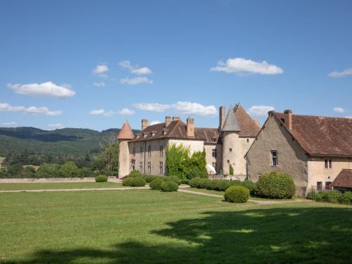 an old castle with a green field and trees at Holiday Home La Maison du Chateau by Interhome in La Tagnière