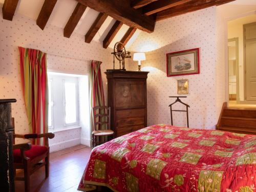 a bedroom with a bed and a chair and a window at Holiday Home La Maison du Chateau by Interhome in La Tagnière