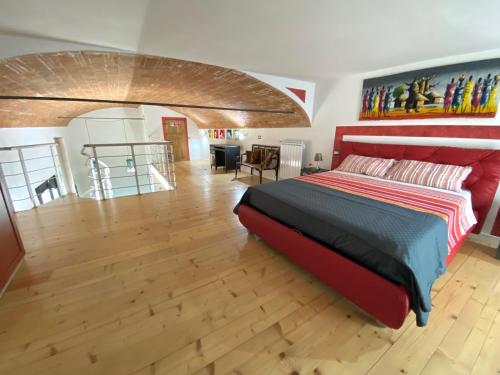 a bedroom with a large bed and a wooden floor at Arno Loft in Florence