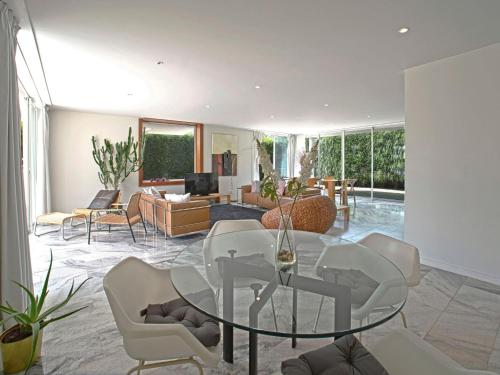 a living room with a glass table and white chairs at Holiday Home Villa Golf by Interhome in Portimão